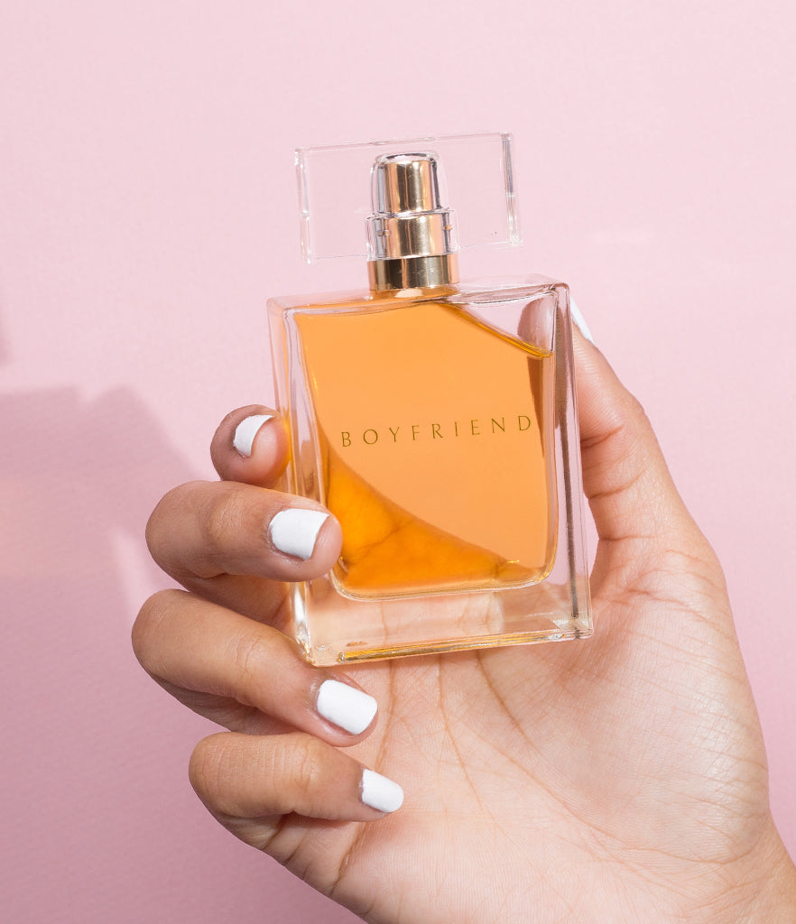 Manicured hand holding 50ml Boyfriend Parfum bottle.