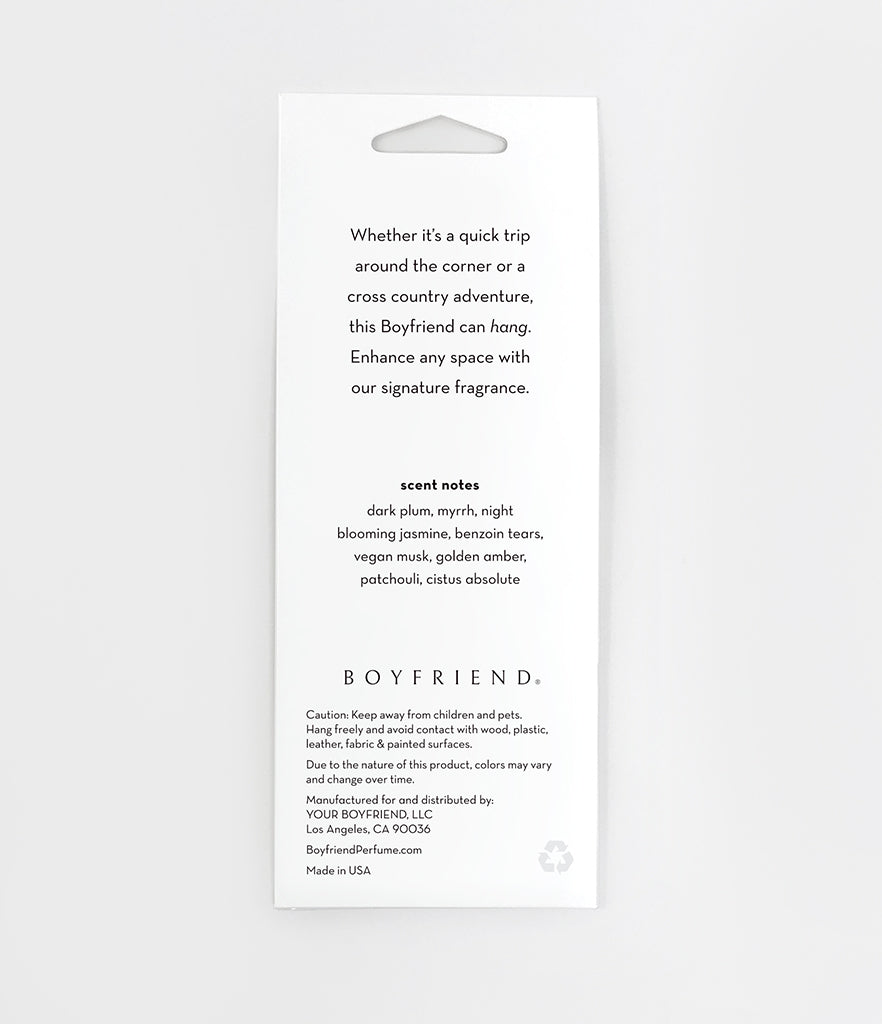 Back of white hanging packing that includes scent notes and disclaimers